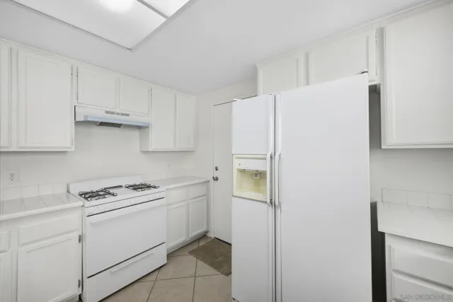 a kitchen with cabinets and white appliances