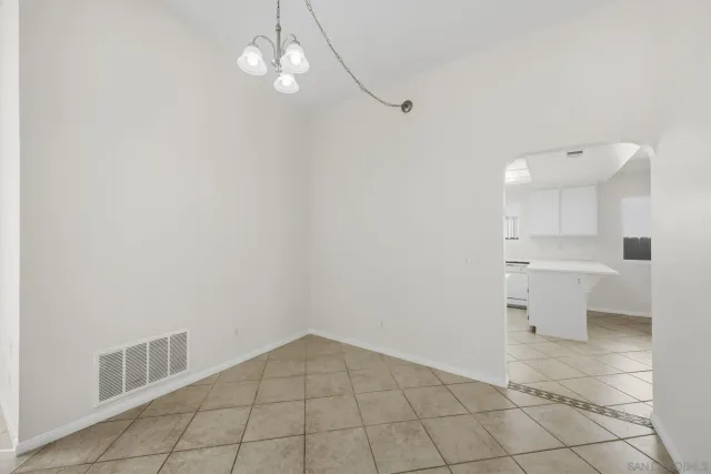 a view of a kitchen with white cabinets and sink
