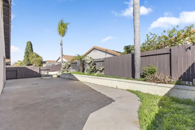a view of a terrace with a bench and potted plants