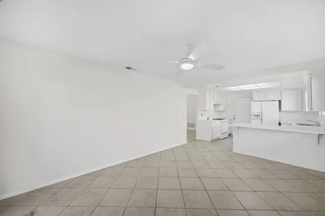 a view of a kitchen with white cabinets