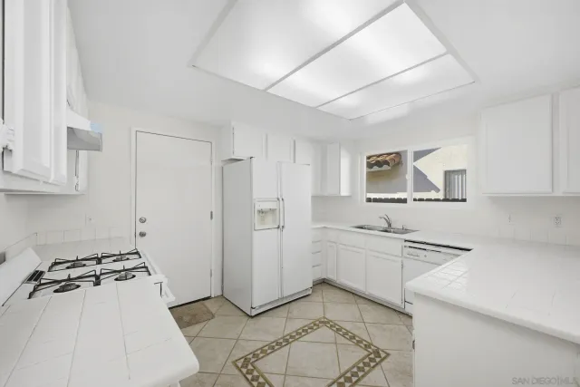 a kitchen with stainless steel appliances granite countertop a sink and cabinets