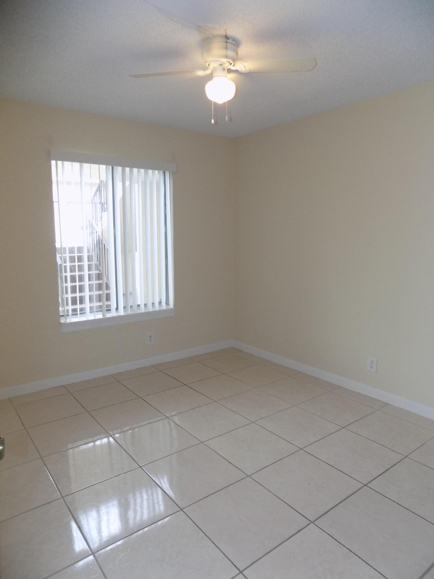 4181 South 57th Avenue, Unit B Greenacres, FL 33463 - Photo 17 of 25 wooden floor in an empty room with a window