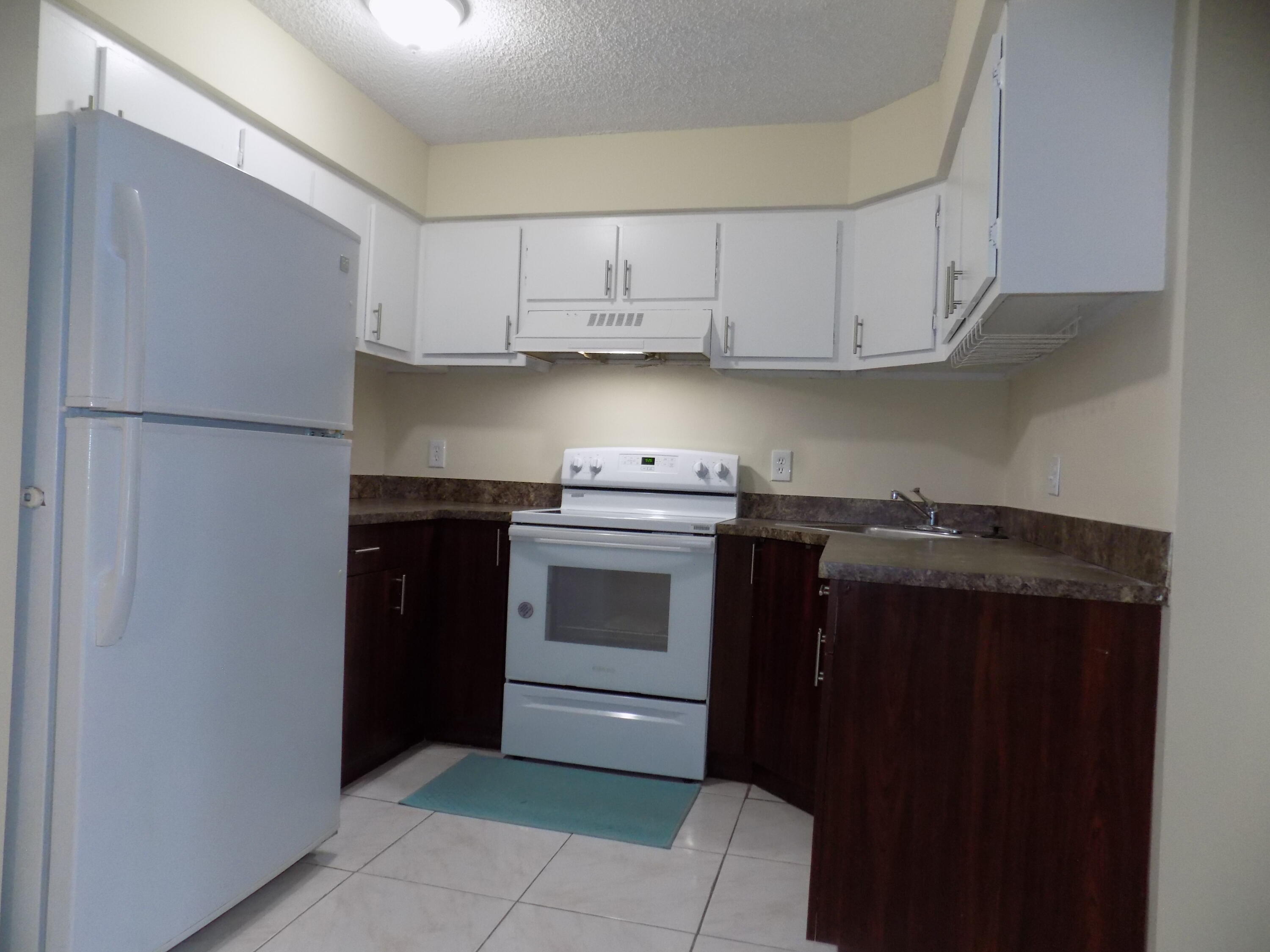 4181 South 57th Avenue, Unit B Greenacres, FL 33463 - Photo 2 of 25 a kitchen with a stove and a sink