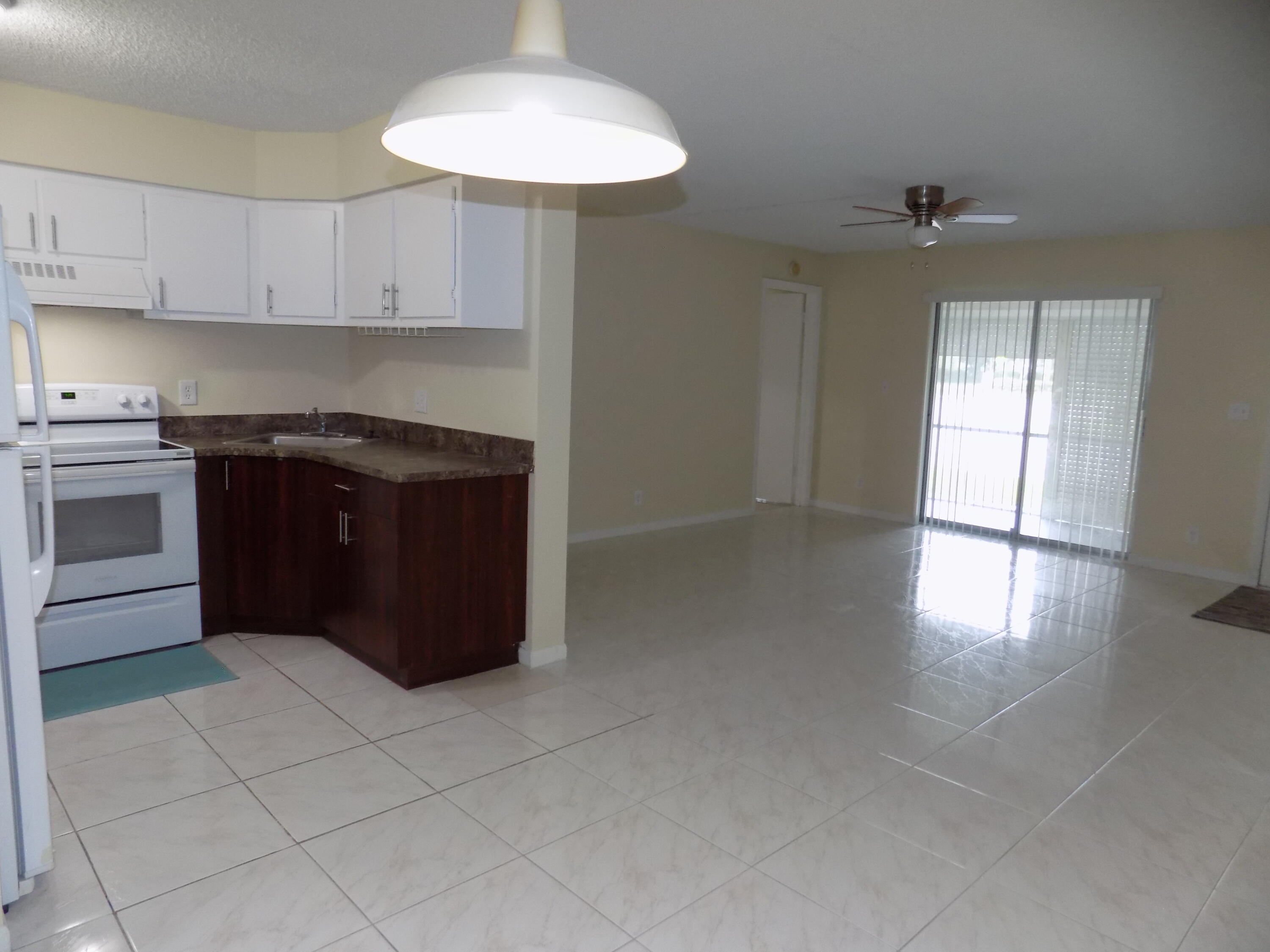4181 South 57th Avenue, Unit B Greenacres, FL 33463 - Photo 5 of 25 a kitchen with a cabinets and window