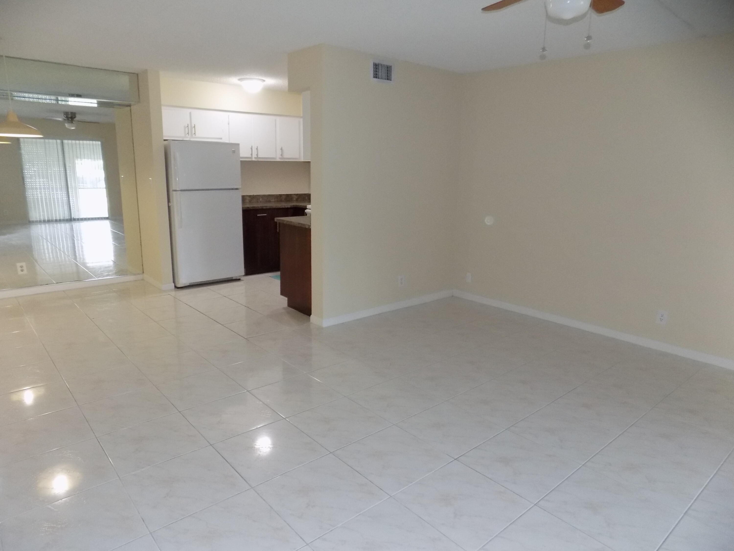 4181 South 57th Avenue, Unit B Greenacres, FL 33463 - Photo 6 of 25 a view of a kitchen with a refrigerator and a sink
