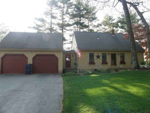 51 Colonial Road Webster, MA 01570 - Photo 3 of 30 a front view of a house with a garden and trees