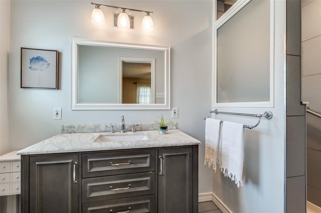 433 Fulton Street Denton, TX 76201 - Photo 16 of 25 a bathroom with a sink and a mirror