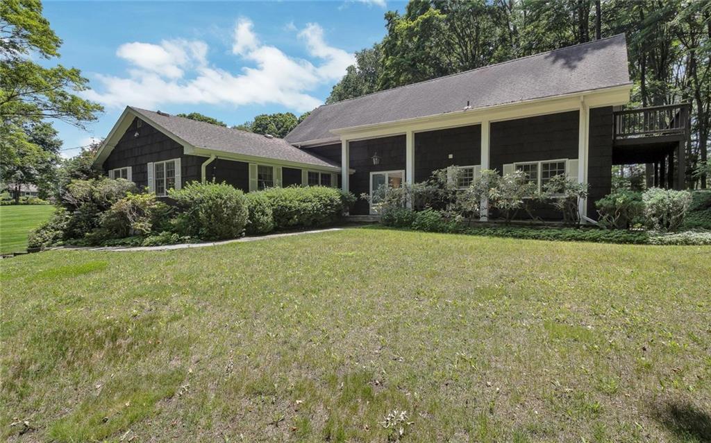 179 Peaceable Street Ridgefield, CT 06877 - Photo 1 of 1 a front view of house with yard and green space
