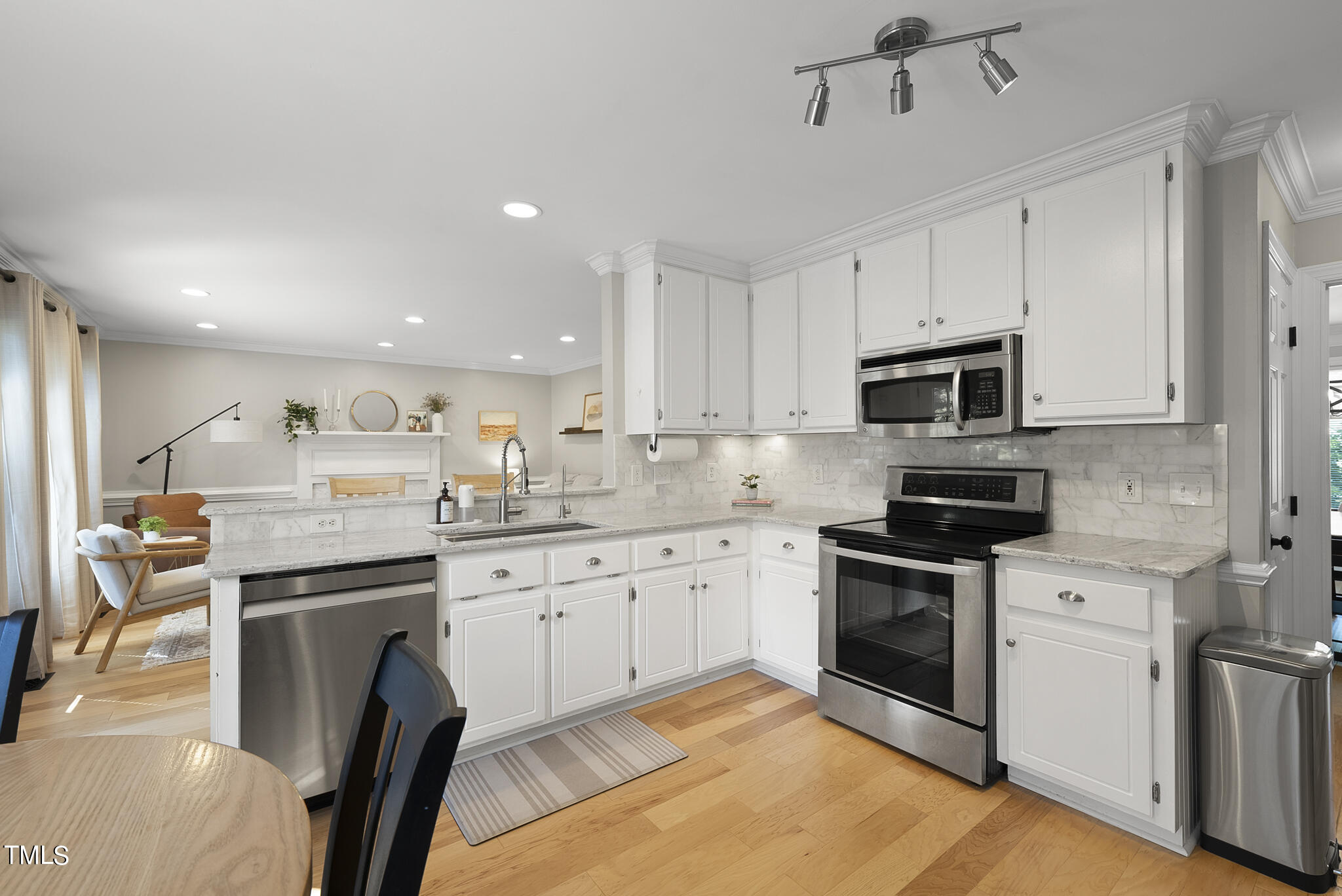 2821 Dahlgreen Road Raleigh, NC 27615 - Photo 2 of 28 a kitchen with stainless steel appliances granite countertop a stove top oven a sink dishwasher and a refrigerator with wooden floor