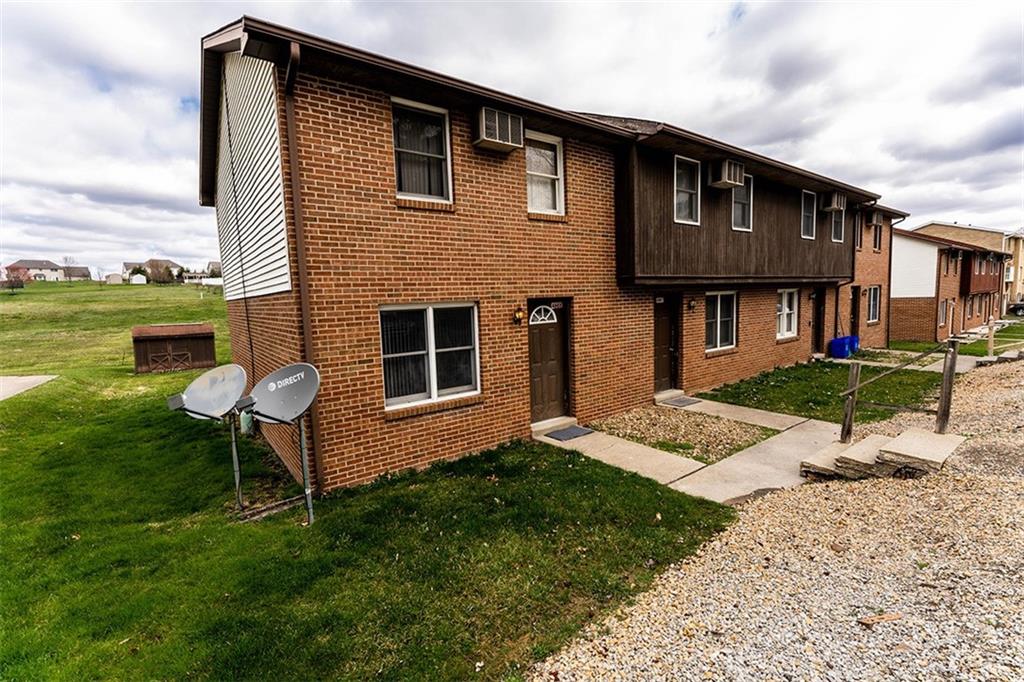 4867 Lucerne Road Indiana, PA 15701 - Photo 1 of 13 a front view of a house with a yard table and chairs