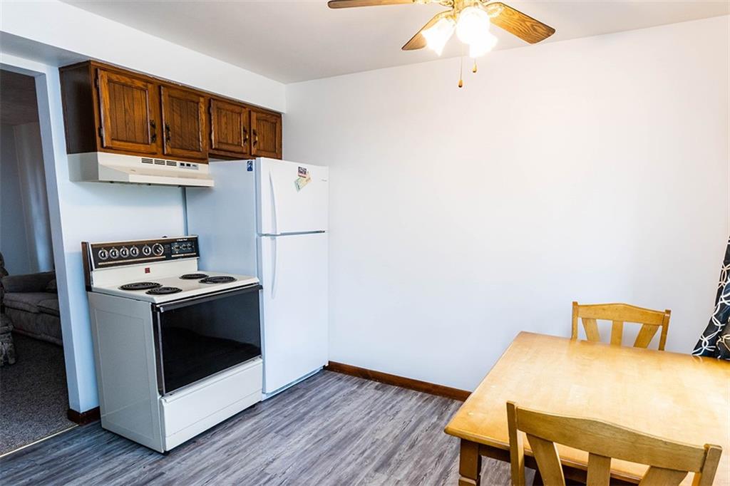 4867 Lucerne Road Indiana, PA 15701 - Photo 3 of 13 a kitchen with stainless steel appliances white cabinets and wooden floor