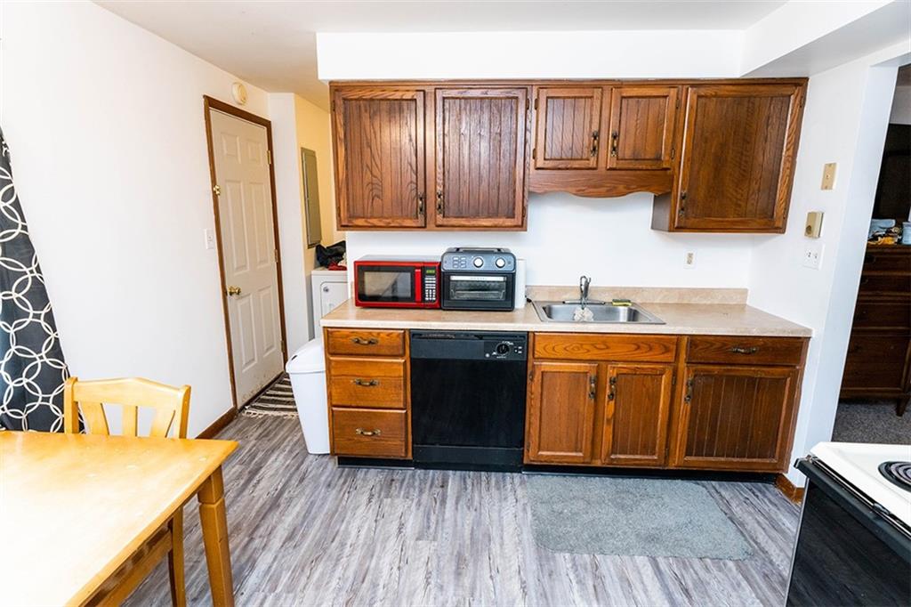 4867 Lucerne Road Indiana, PA 15701 - Photo 4 of 13 a kitchen with stainless steel appliances granite countertop wooden cabinets a sink a stove a refrigerator and dishwasher with wooden floor
