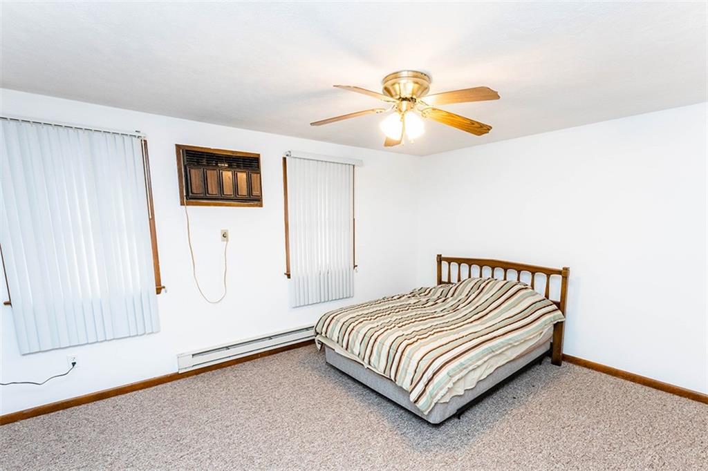 4867 Lucerne Road Indiana, PA 15701 - Photo 7 of 13 a bedroom with a bed and a chandelier