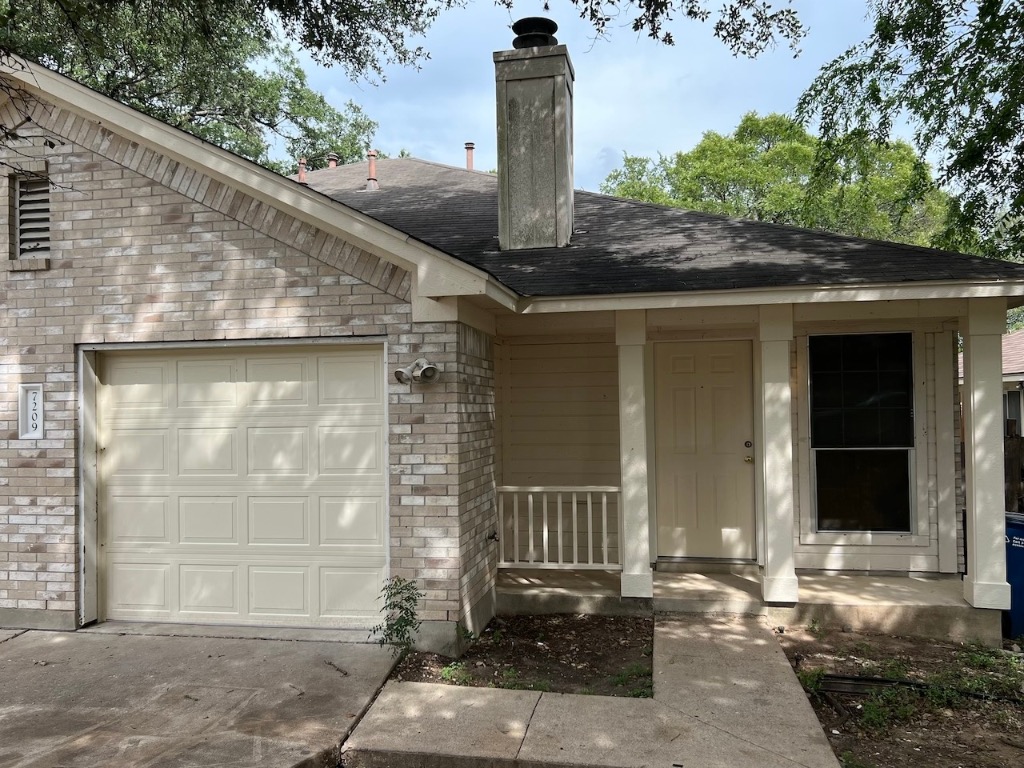 7209 Aldea Drive, Unit B Austin, TX 78745 - Photo 1 of 1 a front view of a house with a garden