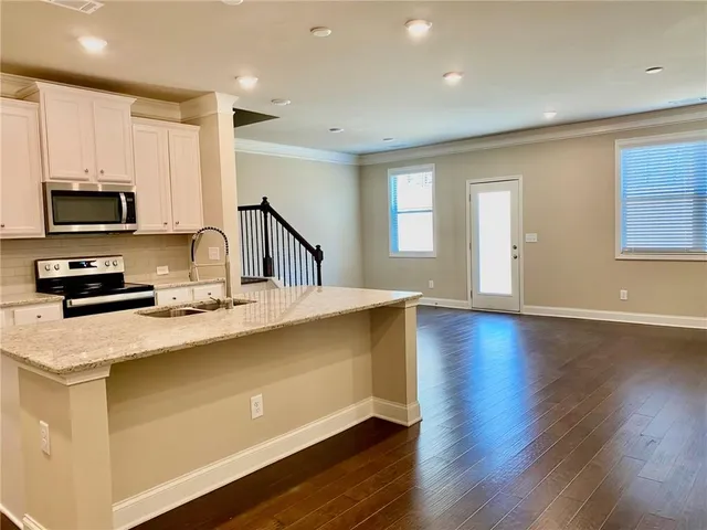 a view of entryway and hall with wooden floor