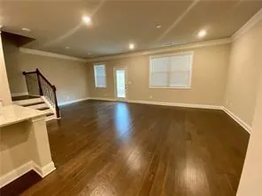 a kitchen with granite countertop white cabinets and a sink