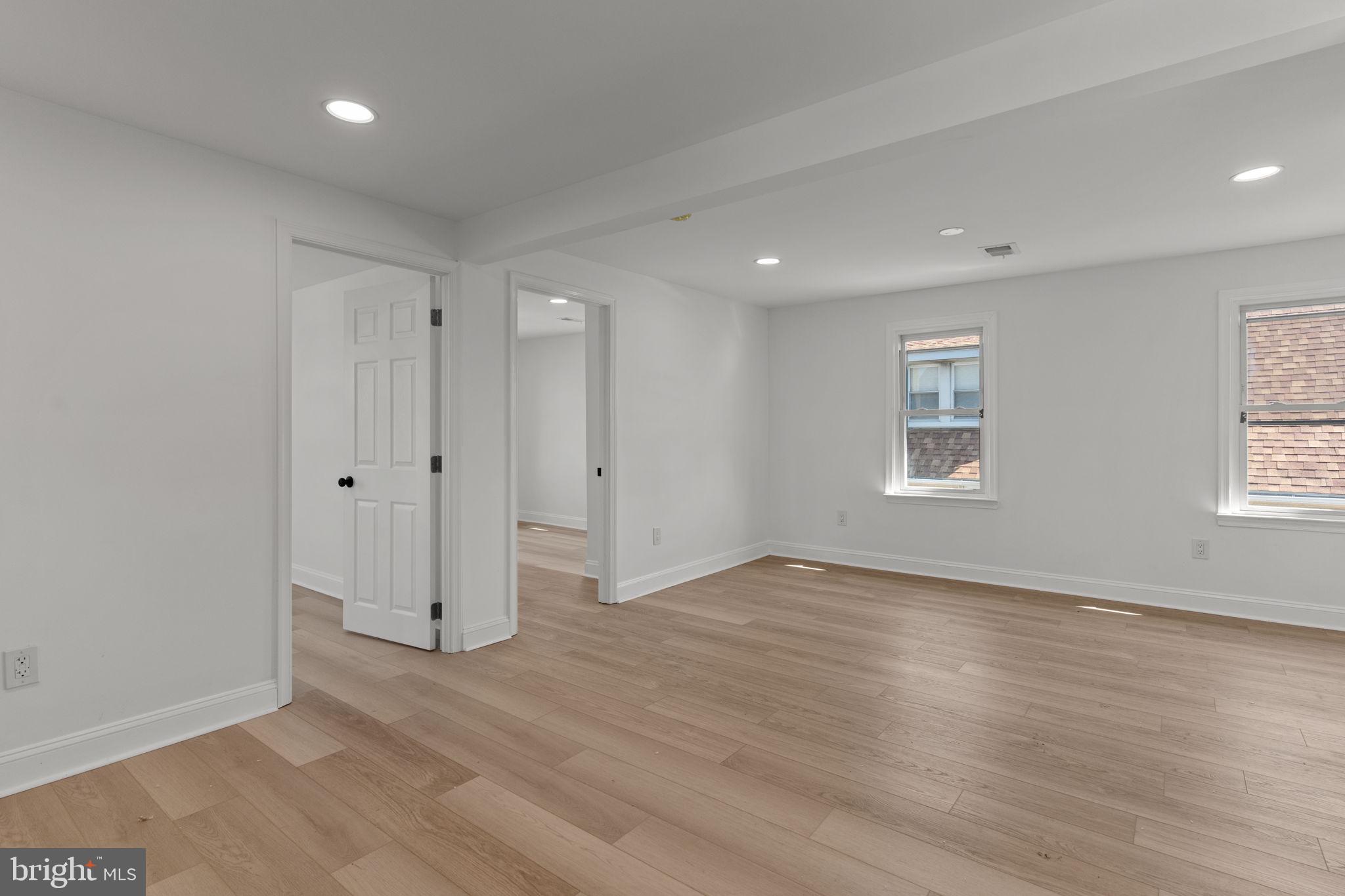 908 State Rd., Unit A Croydon, PA 19021 - Photo 4 of 9 a view of an empty room with wooden floor and a window