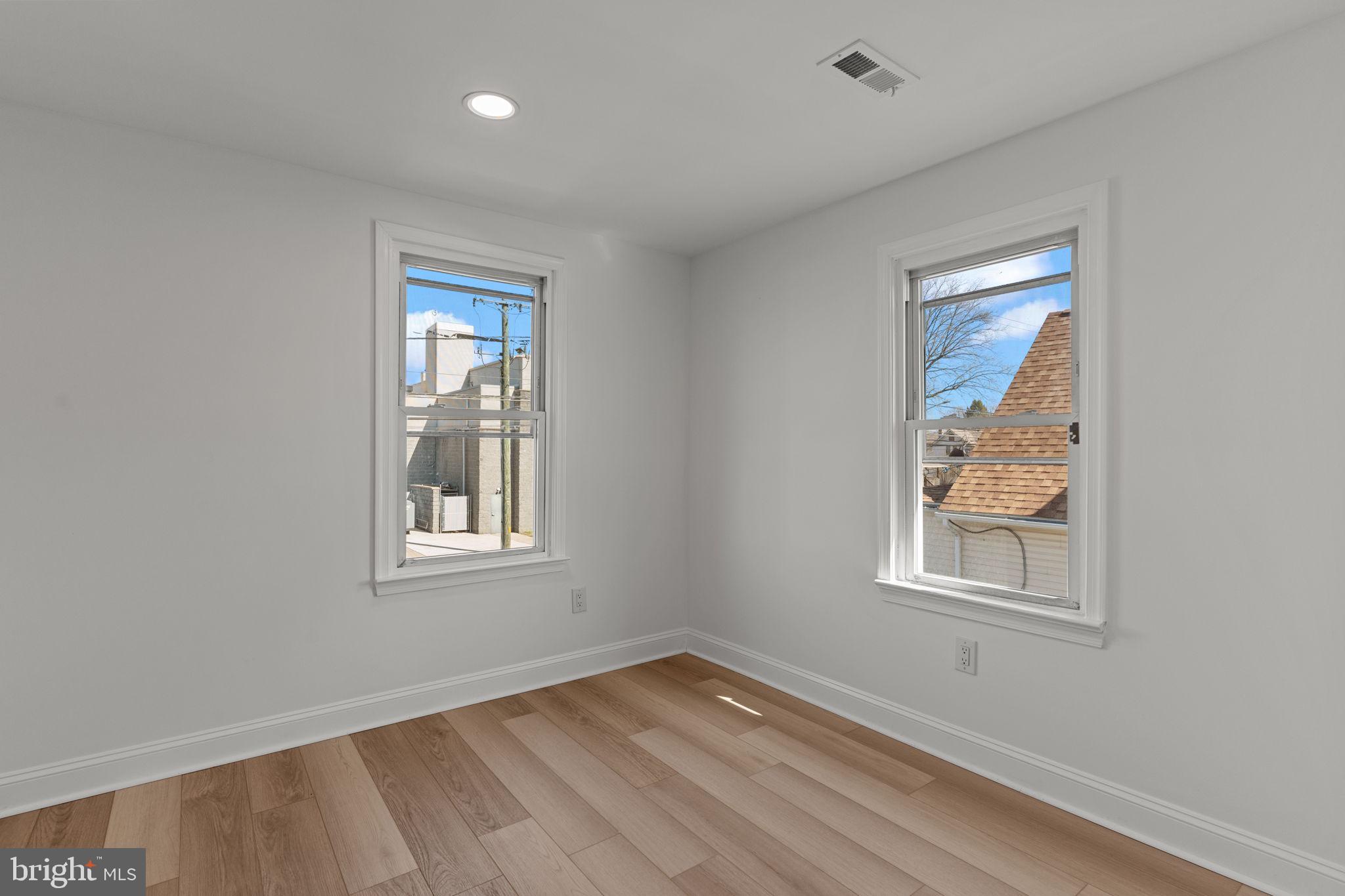 908 State Rd., Unit A Croydon, PA 19021 - Photo 6 of 9 a view of an empty room with wooden floor and a window