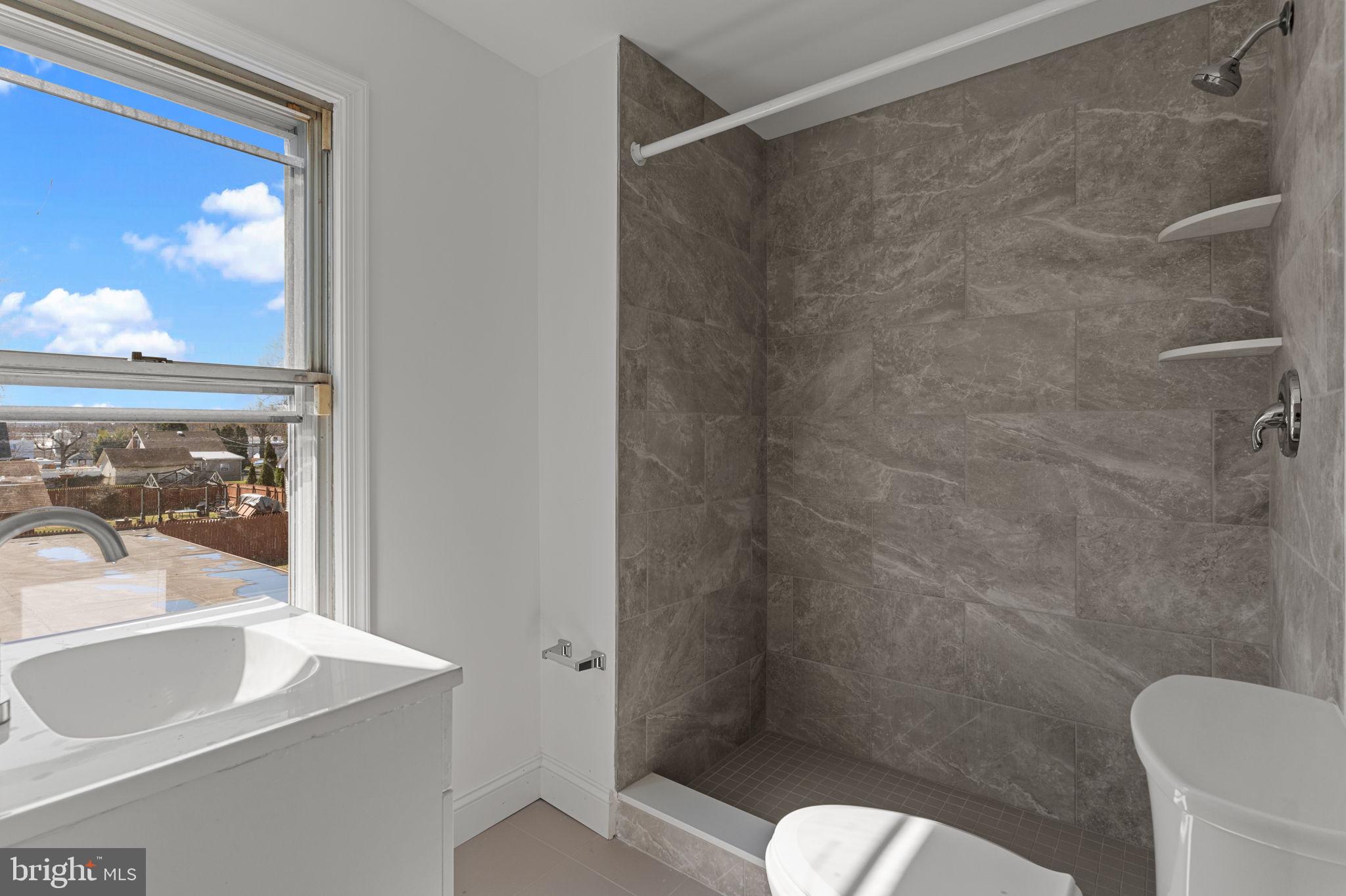 908 State Rd., Unit A Croydon, PA 19021 - Photo 7 of 9 a bathroom with a sink toilet and shower