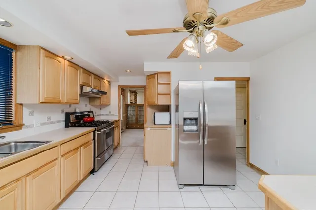 a kitchen with stainless steel appliances a refrigerator sink and microwave