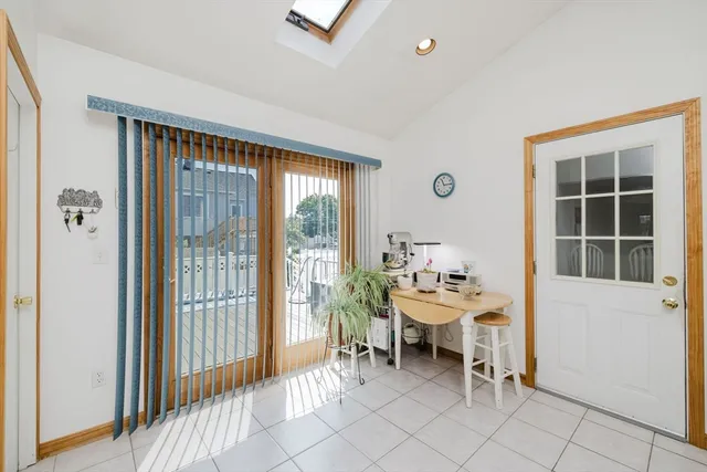 a dining room with furniture and a window