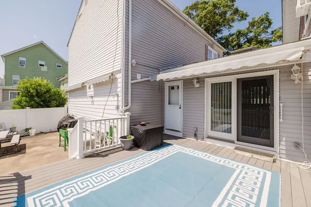 a view of a house with a door and wooden bench