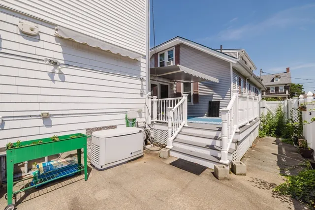 a view of a house with a yard and stairs