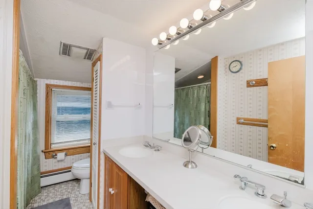 a bathroom with a sink vanity granite and a mirror