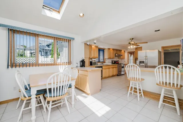 a dining room with furniture and large windows