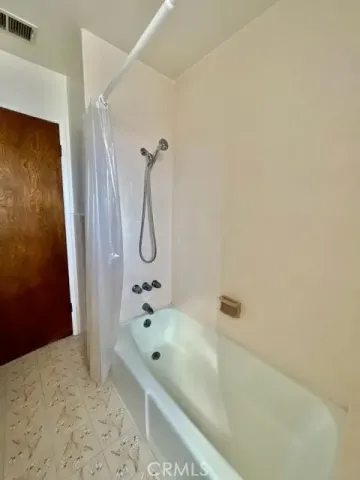 a bathroom with a tub and a shower