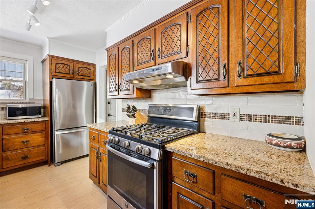 53 Forest Hill Road West Orange, NJ 07052 - Photo 15 of 40 a kitchen with granite countertop stainless steel appliances and cabinets