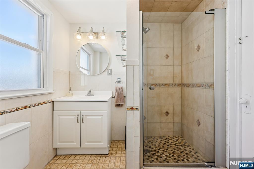 53 Forest Hill Road West Orange, NJ 07052 - Photo 25 of 40 a bathroom with a sink a toilet and shower