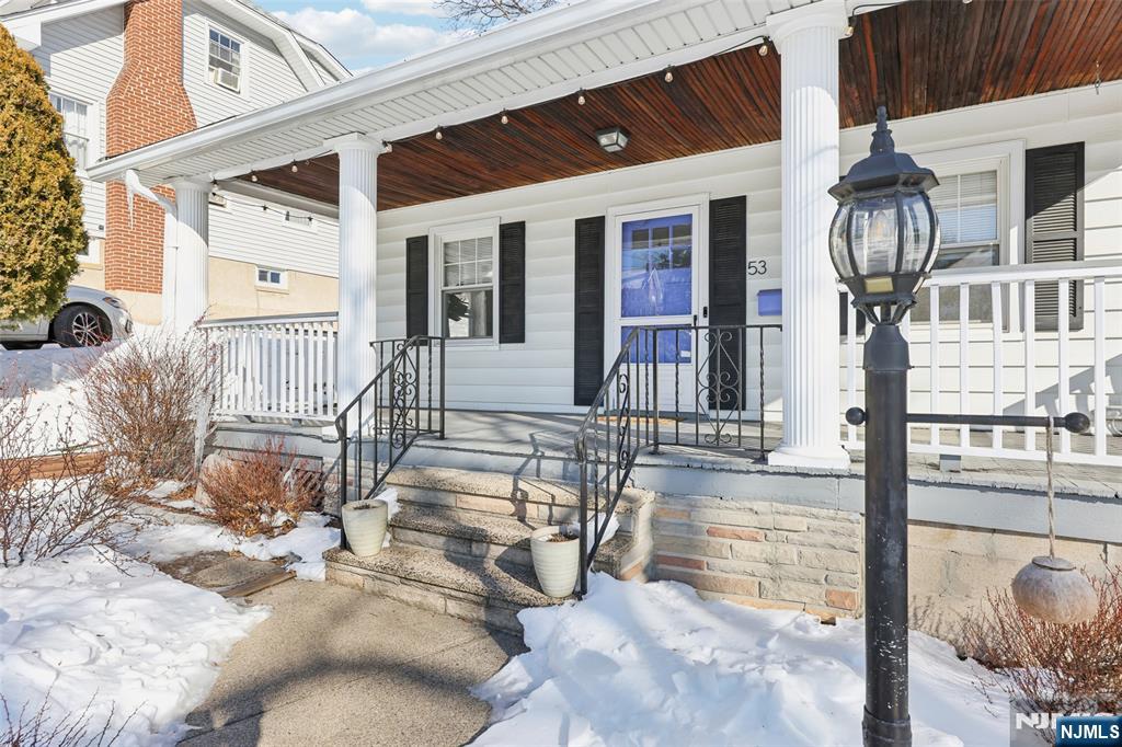 53 Forest Hill Road West Orange, NJ 07052 - Photo 3 of 40 a view of living room kitchen with furniture and floor to ceiling window