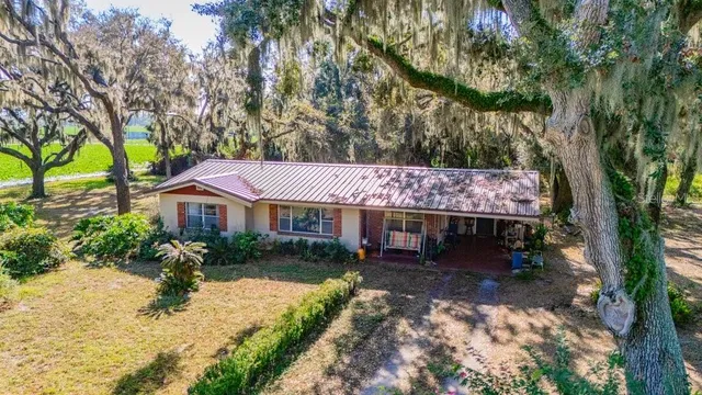 an aerial view of a house with a yard and lake view