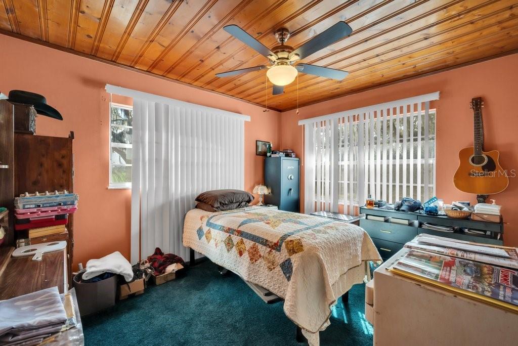 415 Hal Colding Road Lithia, FL 33547 - Photo 30 of 73 a bedroom with bed and a chandelier