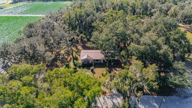 an aerial view of a house with a yard