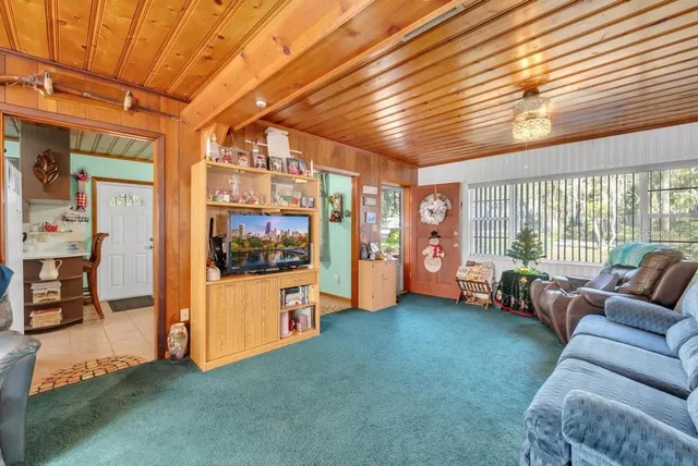 a living room with furniture and kitchen view