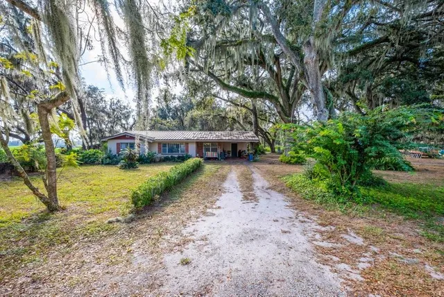 a kitchen with stainless steel appliances granite countertop a stove a sink dishwasher and a microwave oven with cabinets