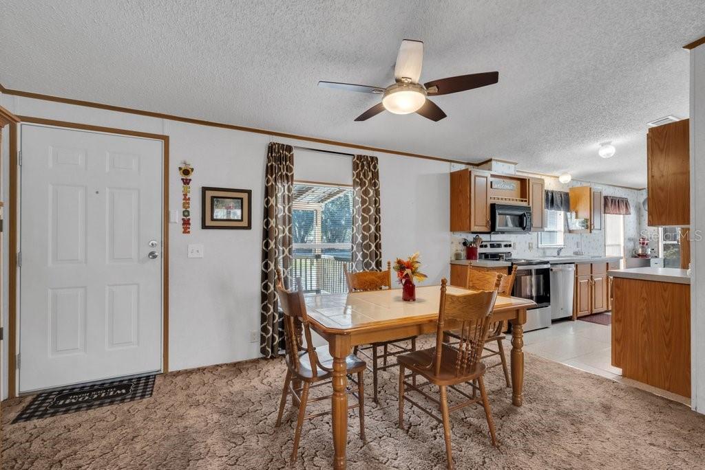 415 Hal Colding Road Lithia, FL 33547 - Photo 59 of 73 a view of a dining room with furniture and a chandelier fan
