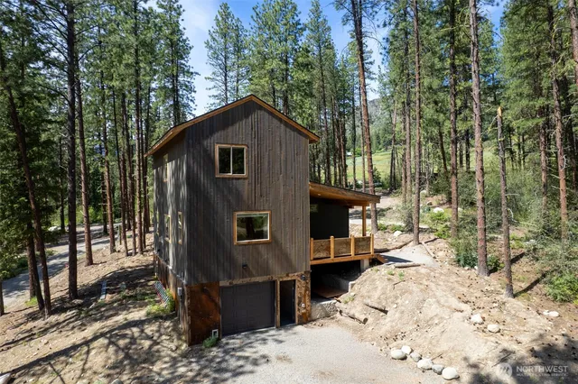 a view of a house with a yard covered in snow