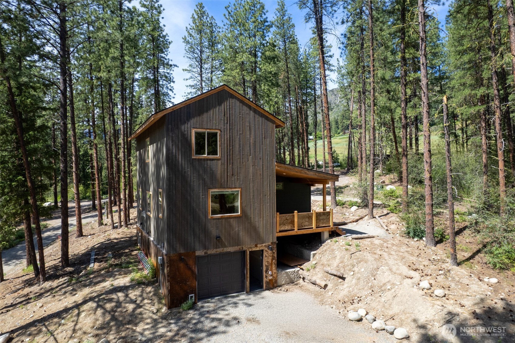 78 Homestead Road Winthrop, WA 98862 - Photo 13 of 40 a view of a house with a yard covered in snow