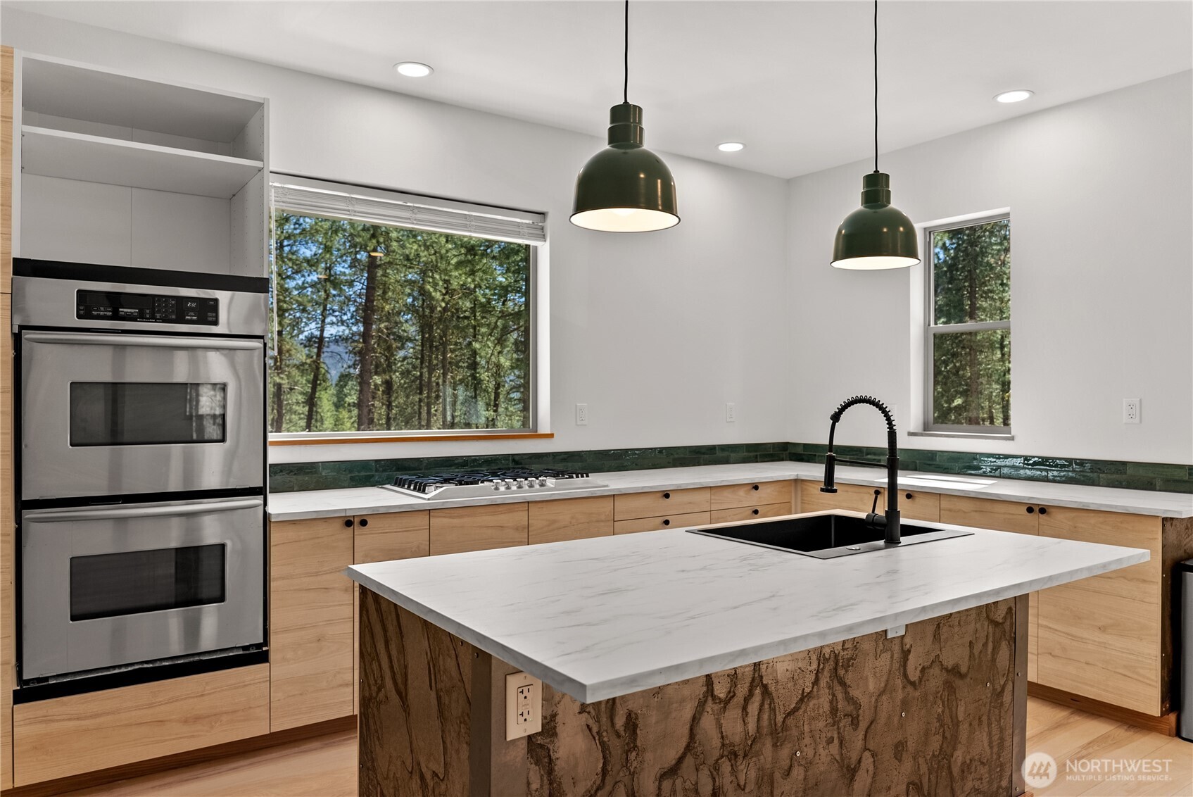 78 Homestead Road Winthrop, WA 98862 - Photo 14 of 40 a kitchen with stainless steel appliances granite countertop a sink a microwave a stove and a wooden floors