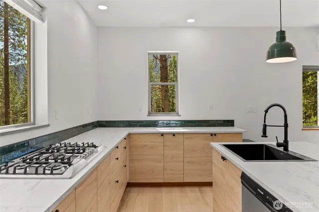 a kitchen with a sink and a stove top oven