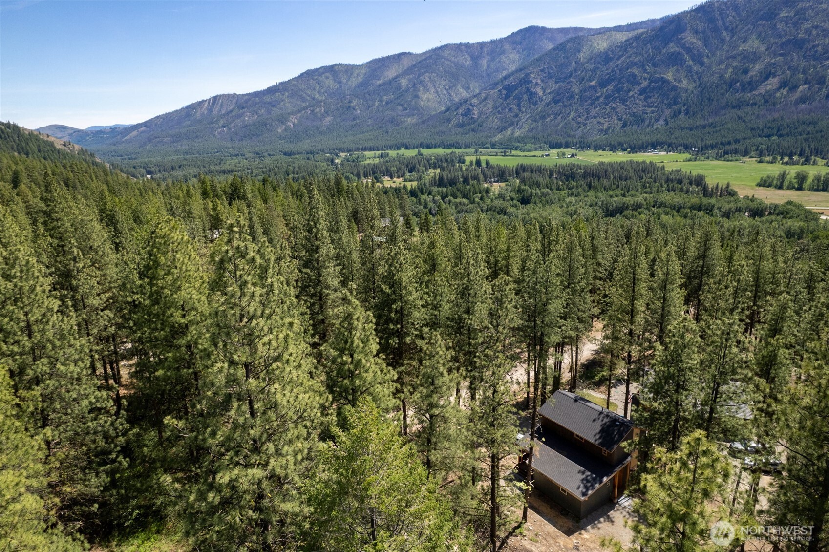 78 Homestead Road Winthrop, WA 98862 - Photo 26 of 40 a view of a lush green hillside and a building