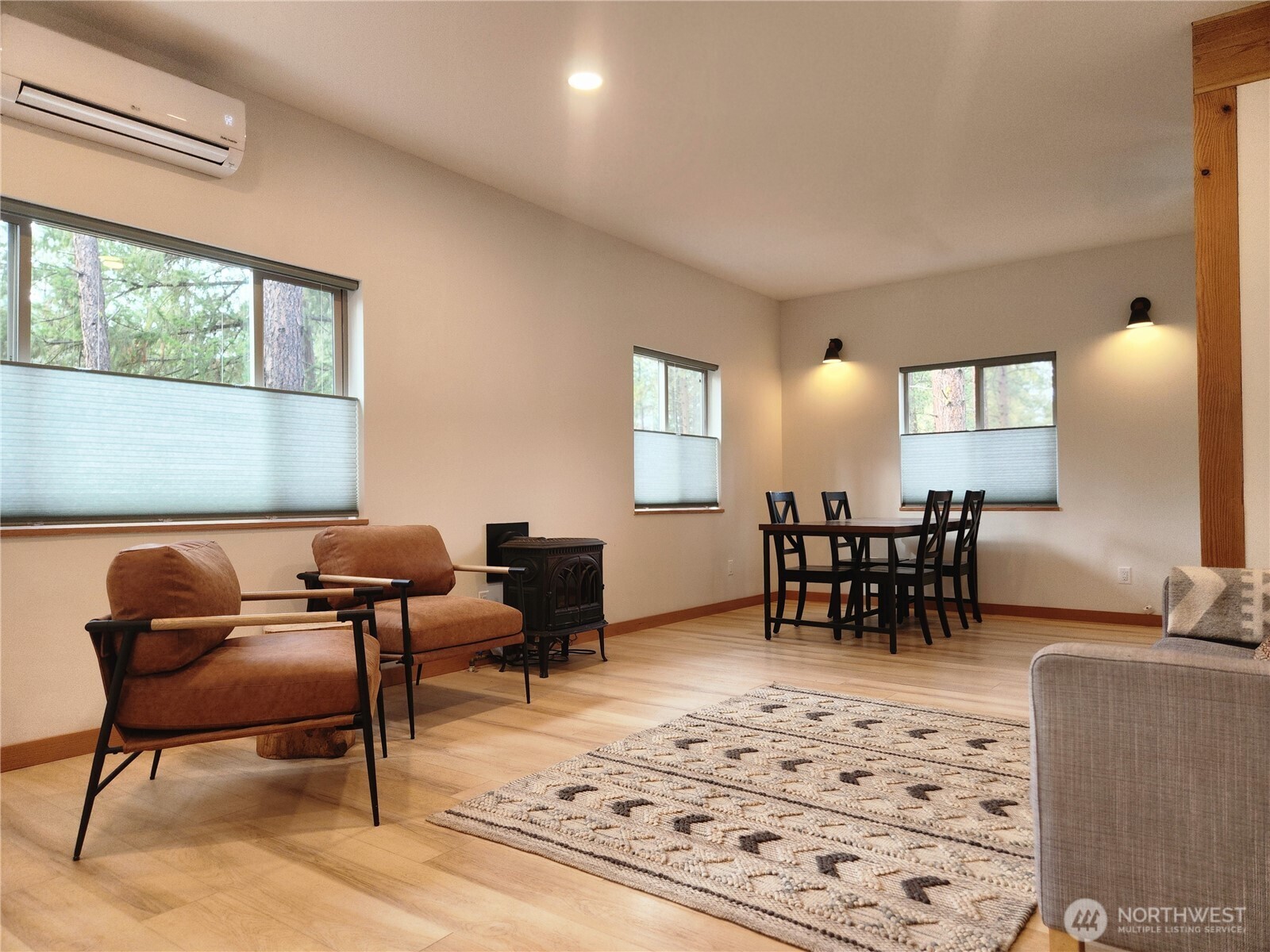 78 Homestead Road Winthrop, WA 98862 - Photo 5 of 40 a living room with furniture and a dining table next to a window