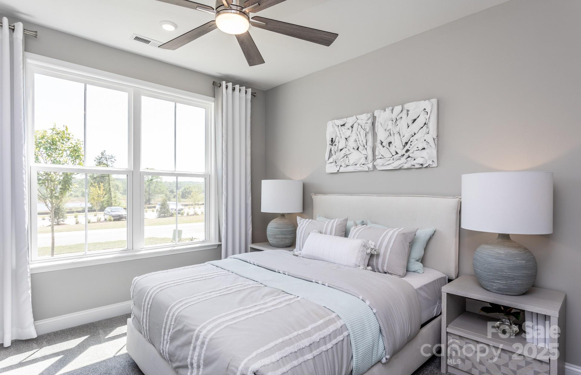 4796 Formation Court, Unit 68 Lancaster, SC 29720 - Photo 13 of 17 a bedroom with a bed and window with chair