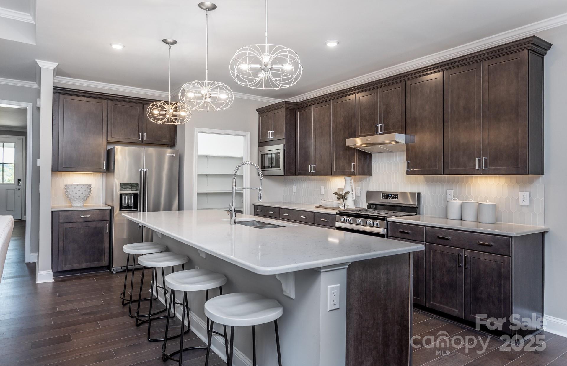 4796 Formation Court, Unit 68 Lancaster, SC 29720 - Photo 2 of 17 a kitchen with stainless steel appliances a stove a sink refrigerator and cabinets