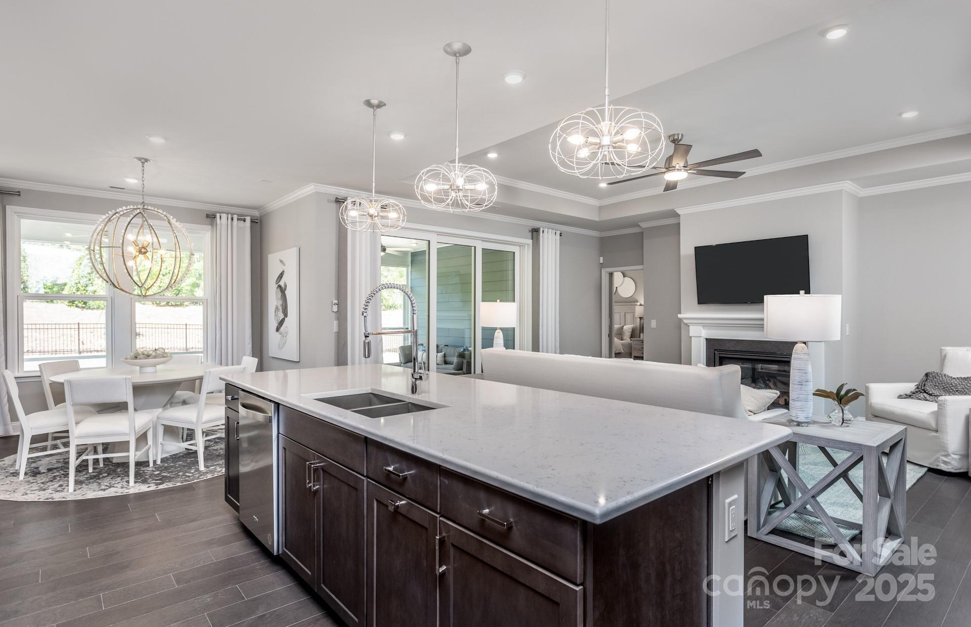 4796 Formation Court, Unit 68 Lancaster, SC 29720 - Photo 4 of 17 a kitchen with a stove a counter space dining table and chairs