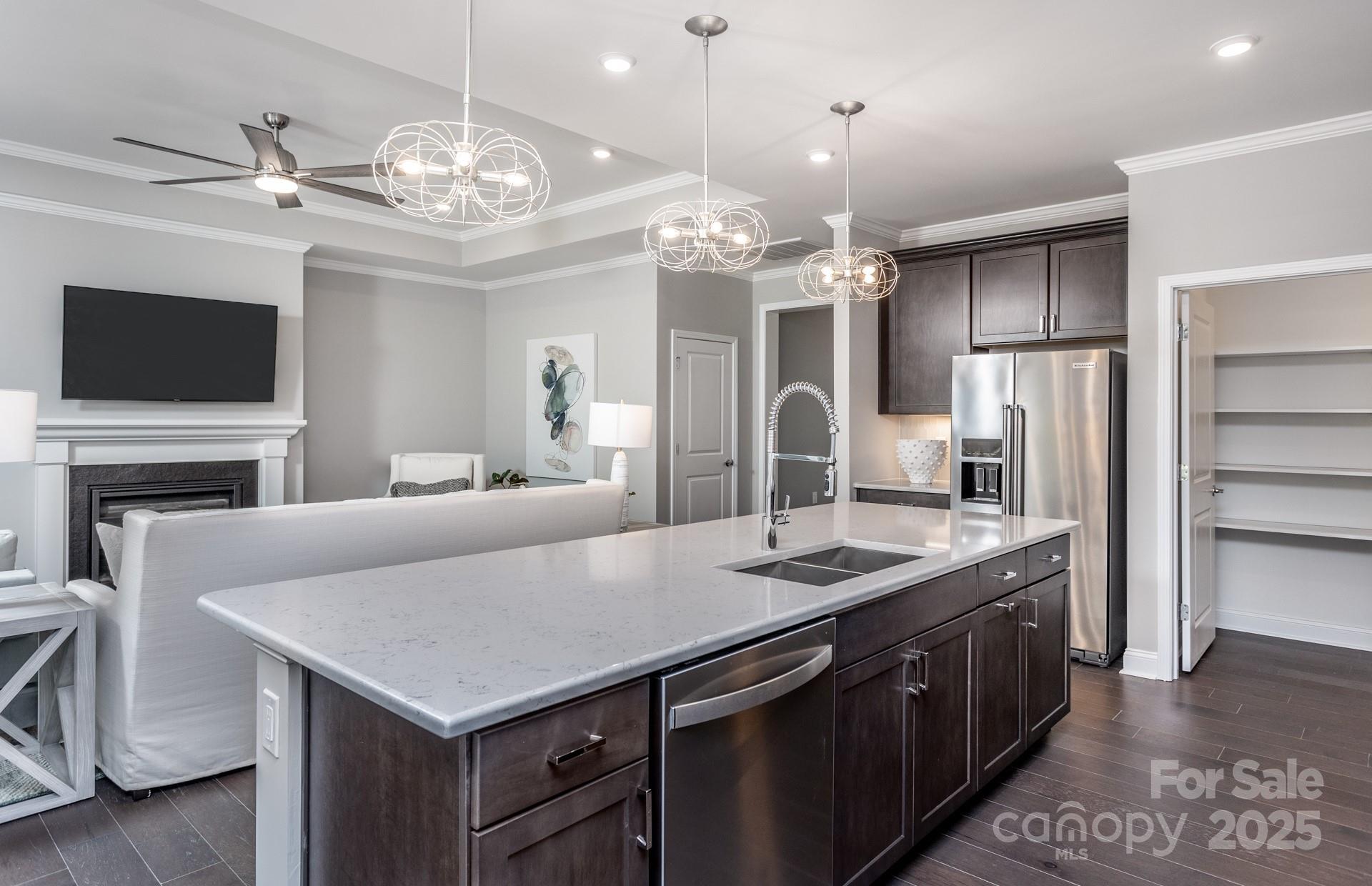 4796 Formation Court, Unit 68 Lancaster, SC 29720 - Photo 5 of 17 a large kitchen with kitchen island a sink counter space stainless steel appliances and a chandelier