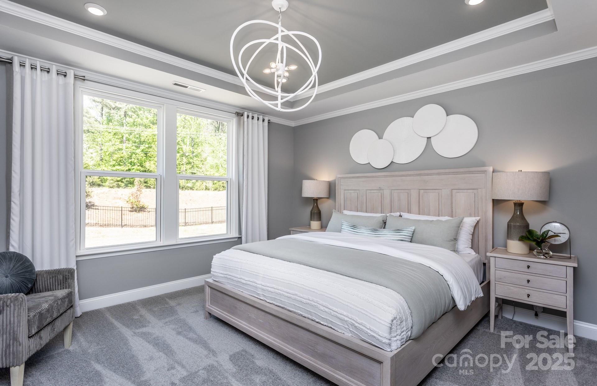 4796 Formation Court, Unit 68 Lancaster, SC 29720 - Photo 10 of 17 a bedroom with bed and a chandelier